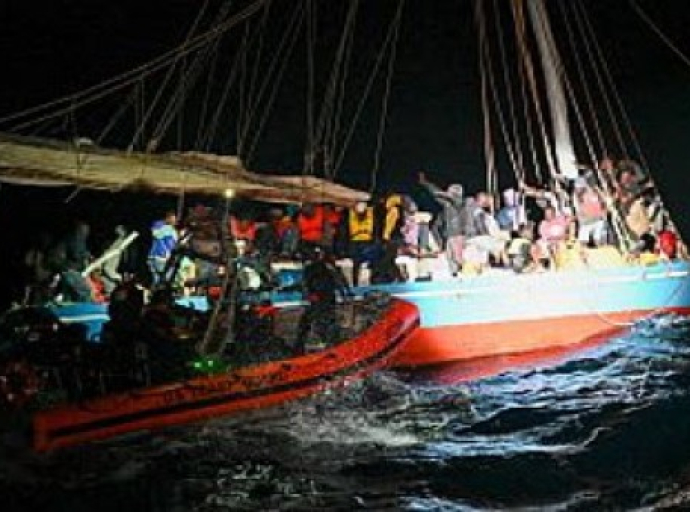 The crew of the USCGC Campbell (WMEC 909) interdicts an overloaded Haitian sail freighter carrying 219 people in the South Florida Straits last month (USCG photo)