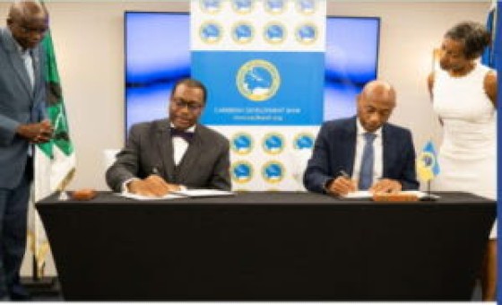 ADB President Dr. Akinwumi Adesina, (left) and CDB President, Dr. Gene Leon sign MOU
