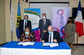 CARPHA Executive Director Dr. Joy St. John and Chief Executive Officer, University Hospital of Martinique, Jérôme Le Brière sign the MOU.