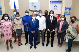 Minister of People Empowerment and Elder Affairs, Kirk Humphrey (5th from right) and Parliamentary Secretary in the Ministry of People Empowerment and Elder Affairs, Corey Lane (4th from right), pose with members of Advisory Committee to guide the establishment of a Commission for Improving the Lives of Persons with Disabilities. The Committee is chaired by Edmund Hinkson (center). (C. Pitt/BGIS)