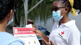 Guyana Red Cross distributing info on how to stay safe from COVID. (IFRC photo) 