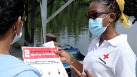 Guyana Red Cross distributing info on how to stay safe from COVID. (IFRC photo)