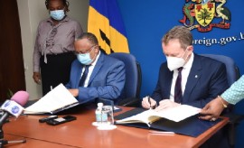 Barbados Foreign Affairs and Foreign Trade Minister, Dr. Dr Jerome Walcott (Left) and INTERPOL executive director of Police Services, Stephen Kavanagh signing agreement (Photo courtesy BARBADOS Today)