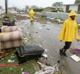 Residents survey Hurricane Ivan damage in Jamaica in 2004 (Reuters)