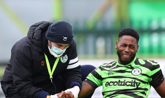 Jamille Matt receives on-field medical attention for his injured hand.