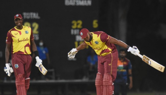 Kieron Pollard takes a bow as Jason Holder looks on after hitting six sixes in one over against Sri Lanka on Wednesday night, March 3, 2021. (Photo: CWI Media/Philip Spooner/CMC)