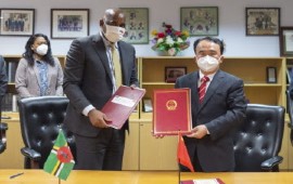 Prime Minister Roosevelt Skerrit (Left) and Chinese Ambassador Lin Xianjiang, show off the agreement (GIS Photo)