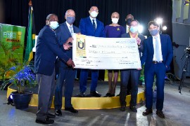 Prime Minister Holness (third from the left) symbolically presents a J$20 million check to the Public Broadcasting Corporation of Jamaica. (JIS Photo)