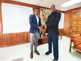 Richard Pandohie, CEO of Seprod; receives award from Leighton “Fyah” McKnight, David “Wagga” Hunt Committee Member