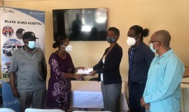 CEO for the Black River Hospital, Diana Brown-Miller (3rd right) accepts the cheque of US $15,000 from Peggy Ewen, family friend of donor Dave  Johnson (left), while Senior Medical Officer for the hospital, Dr. Sheriff Imoru (2nd right) and Parish Manager for the St. Elizabeth Health Services, Sean Brissett look on.