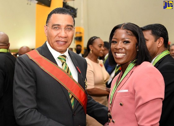 Prime Minister, the Most Hon. Andrew Holness (left) greets Olympian Shericka Jackson after she was conferred with the Order of Distinction in the rank of Commander (CD) during the 2022 Ceremony of Investiture and Presentation of National Honours and Awards, held at King’s House on Monday (October 17). (Photo via JIS)