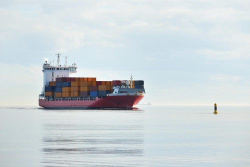 Large container ship sailing in still sea water