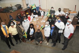 At Econo-Caribe Shipping warehouse in Queens, NY, members of UJAA brave the icy New York weather to deliver boxes of laptops and tablets for shipment to students in Jamaica. UJAA photo