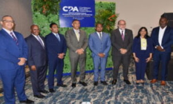 Prime Minister Andrew Holness (in brown suit) with officials attending the Caribbean Poultry Association conference that ends on Thursday (JIS Photo)