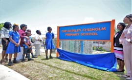 Prime Minister Mia Amor Mottley, officials and the family of Shirley Chisholm watch the unveiling of the new sign bearing the name of former pupil and trailblazer Shirley Anita Chisholm. (C. Pitt/BGIS)