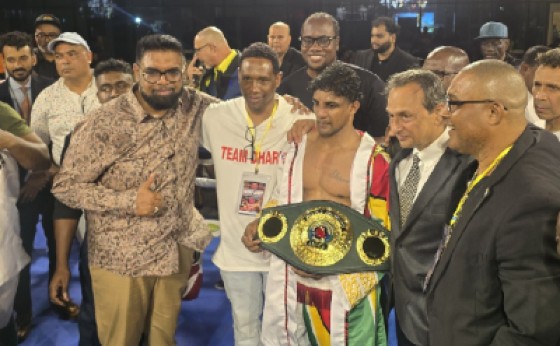Elton Dharry poses with his (IBO) Super Bantamweight belt. Also pictured is Guyana President Irfaan Ali (left).