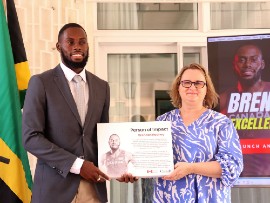 Canadian Olympian Brendon Rodney receives the 'Person of Impact' recognition award from the Canadian High Commissioner Emina Tudakovic at the launch of Rodney's Life Beyond Sports Foundation and Scholarship Awards on May 30, 2023, at the Official Residence of Canada.