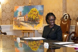 Permanent Representative of St. Vincent and the Grenadines, Louanne Gilchrist with the painting by artist Calvert Jones.