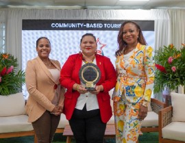Candace Phillips of the Guyana Tourism Authority accepts the Community-Based Tourism Award on behalf of Guyana Inni Lodge — Toka Village. She is flanked by Charlene Drakes of Carnival Corporation & plc (left) and Dona Regis-Prosper of the Caribbean Tourism Organization.