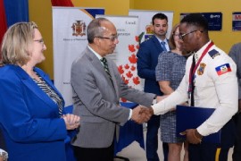 National Security Minister Dr. Horace Chang congratulates members of the Haitian National Police (HNP) . Canada’s High Commissioner to Jamaica, Emina Tudakovi looks on (JIS Photo)
