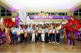 Caribbean Airlines’ CEO Garvin Medera (backrow) and other members of management and staff celebrate the success of the airline’s ‘Carnival Customer Appreciation’ activity, held in collaboration with a number of stakeholders at the Piarco International Airport on February 16.