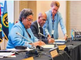 Barbados Prime Minister Mia Mottley, then CARICOM chair, signs the agreement signed on 20 February 2025 in Bridgetown (CMC File Photo)