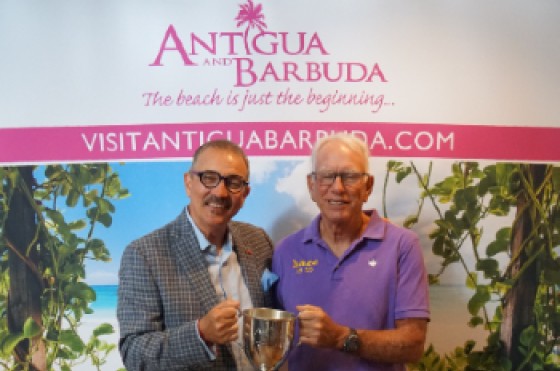 Photo Caption: Hon. Charles Fernandez, Minister of Tourism, Civil Aviation, Transportation, and Investment, and winning slipper Lee Oldak