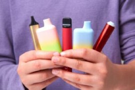 Young person holding vapes
