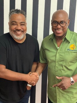 Bobby Clarke (L), Chairman of the Bridge 99FM welcomes radio host Richard 'Richie B' Burgess to the new station