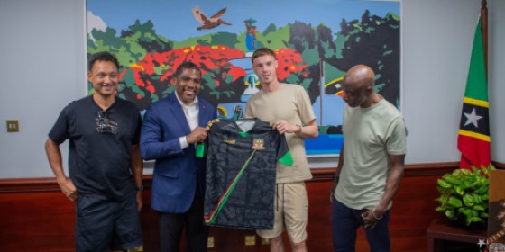 Chelsea footballer Cole Palmer (second right) accepts a St Kitts & Nevis football jersey from Prime Minister Terrance Drew (second left) during his trip to St Kitts & Nevis.