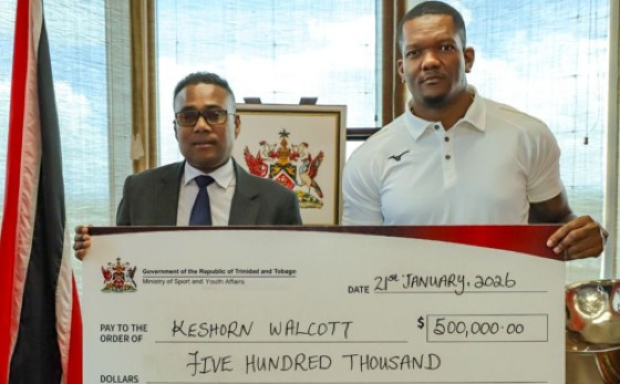 World Champion Keshorn Walcott (right) accepts his award from Minister of Sport and Youth Affairs, Phillip Watts