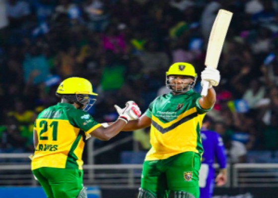 Jamaica Kingsmen batsman Andre Russell raises his bat after reaching his half-century against the Barbados Tridents. Photo:CPL