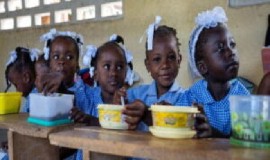 Children in Haiti eat a hot meal provided by the UN and partners at school (UN Photo)