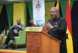 President of the Republic of Ghana, John Dramani Mahama (at podium), addresses a reparatory justice dialogue at the University of the West Indies (UWI) Regional Headquarters. At left is Chairman of the Caribbean Community (CARICOM) Reparations Commission, Sir Hilary Beckles. (Photo credit: JIS)