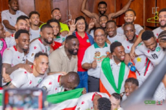 President of Suriname Jenny Simons and vice-president Gregory Rusland (centre), celebrate with the Natio players in the locker room after their victory over El Salvador.