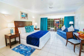 A newly renovated Junior Executive Suite with King bed with Caribbean blue accents