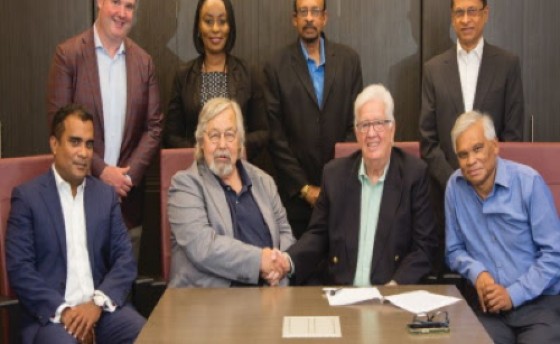 TT Iron Steel founder, president and CEO Gus Hiller, seated second from left, shakes hands with liquidator of ArcelorMittal Point Lisas Ltd, Christopher Kelshall, following the signing of the sale and purchase agreement for the iron and steel plant in June 2023