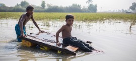 Children make their way home through contaminated floodwater in Jacobabad, Sindh province, Pakistan. (Photo courtesy of UNICEF/Saiyna Bashir)