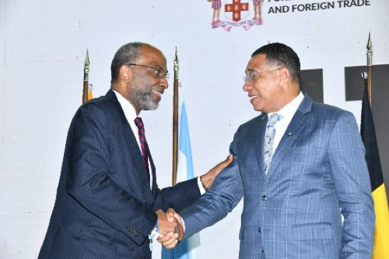 Earl Jarrett (left), Chief Executive Officer of The Jamaica National Group and chair of the conference, greets Prime Minister Andrew Holness the at the opening of the 11th Jamaica Diaspora Conference held at the Montego Bay Convention Centre on Tuesday.