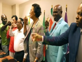 Presidential candidate-elect, Jennifer Geerlings-Simons (center) join the chairmen of the six parties for a toast after signing the agreement on Tuesday night.