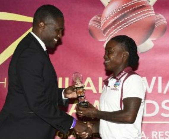 Dottin, right, receives one of her awards from WIPA President Wavell Hinds.