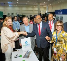 Monica Mass Tinoco, Executive Director of COTELCO Cartagena (left), greets Jamaica's Minister of Tourism Edmund Bartlett during Caribbean Travel Marketplace in Montego Bay. From left are Frank Comito, CEO of the Caribbean Hotel and Tourism Association (CHTA); David Noel, President and CEO of Scotiabank Group Jamaica; and CHTA President Patricia Affonso-Dass.