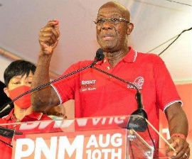 Rowley, right, addresses supporters following his win. At his side is wife Sharon.