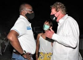 Jamaica’s Director of Tourism Donovan White (left) speaking with Robert Burke, President and CEO of e-Group Communications at the Land X-Change closing dinner at Sandals Cay. Looking on is Stella Horan, Global Director of Marketing for e-Group Communications.