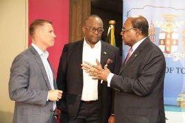 Tourism Minister, Hon. Edmund Bartlett (right) engages  CEO and Deputy Chairman of the Sandals Resorts International Adam Stewart (left) and Director of Tourism, Donovan White in conversation ahead of a press briefing at the Jamaica Tourist Board’s New Kingston office. During the briefing, Minister Bartlett stated that the Global Tourism Resilience and Crisis Management Centre has begun to mobilise resources to assist the Bahamas following the devastating effects of hurricane Dorian. One such partner in their relief efforts is the Sandals Resorts International Foundation.   