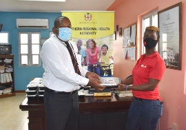 Regional Director for the SRHA, Michael Bent (left) accepts the donation of cooked meals for essential frontline workers within the Southern Regional Health Authority (SRHA) from the CB Group Outreach Coordinator, Roxanne Isaacs. The first batch of lunches was distributed on Tuesday, June 16 to the healthcare workers in Manchester, followed by distribution in Clarendon on June 17 and in St. Elizabeth on June 19.