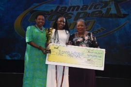 2019 Jamaica Gospel Song Winner, Joanna Walker (centre) receives her winning trophy from the Hon Olivia Grange, Minister of Culture, Gender, Entertainment and Sport (left) a cheque for one million dollars from Carole Guntley, Board Commissioner, Jamaica Cultural Development Commission at the Gospel Song Grand Final at the National Arena on Sunday.