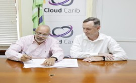 OECS Director General. Dr. Didacus Jules and Cloud Carib director, Eamonn Sheehy signing MoU