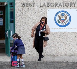 A student gathers her things as she prepares to enter Henry S. West Laboratory School in Coral Gables on Oct. 5. Carl Juste/Miami Herald