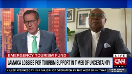 CNN’s Richard Quest (left) chats with Minister Edmund Bartlett last week.